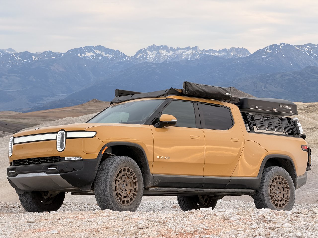Compass Yellow Rivian R1T in the mountains