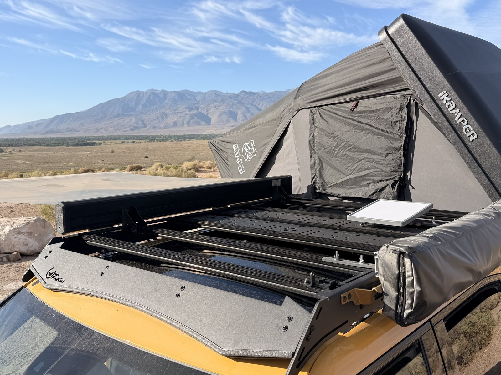 Prinsu roof rack with the Skycamp tent open above the Rivian cab