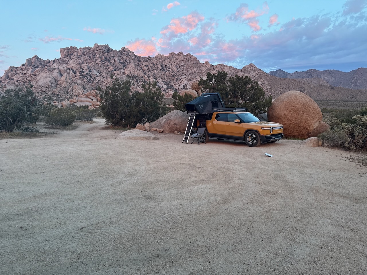 iKamper rooftop tent mounted on the Rivian at camp